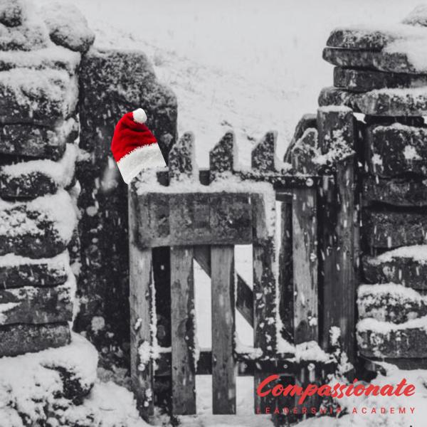 Gates A picture of a gate in the snow with a santa hat on one of the posts.